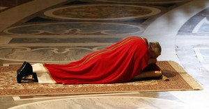 Pope Francis lies as he prays during the Celebration of the Lord's Passion in Saint Peter's Basilica at the Vatican